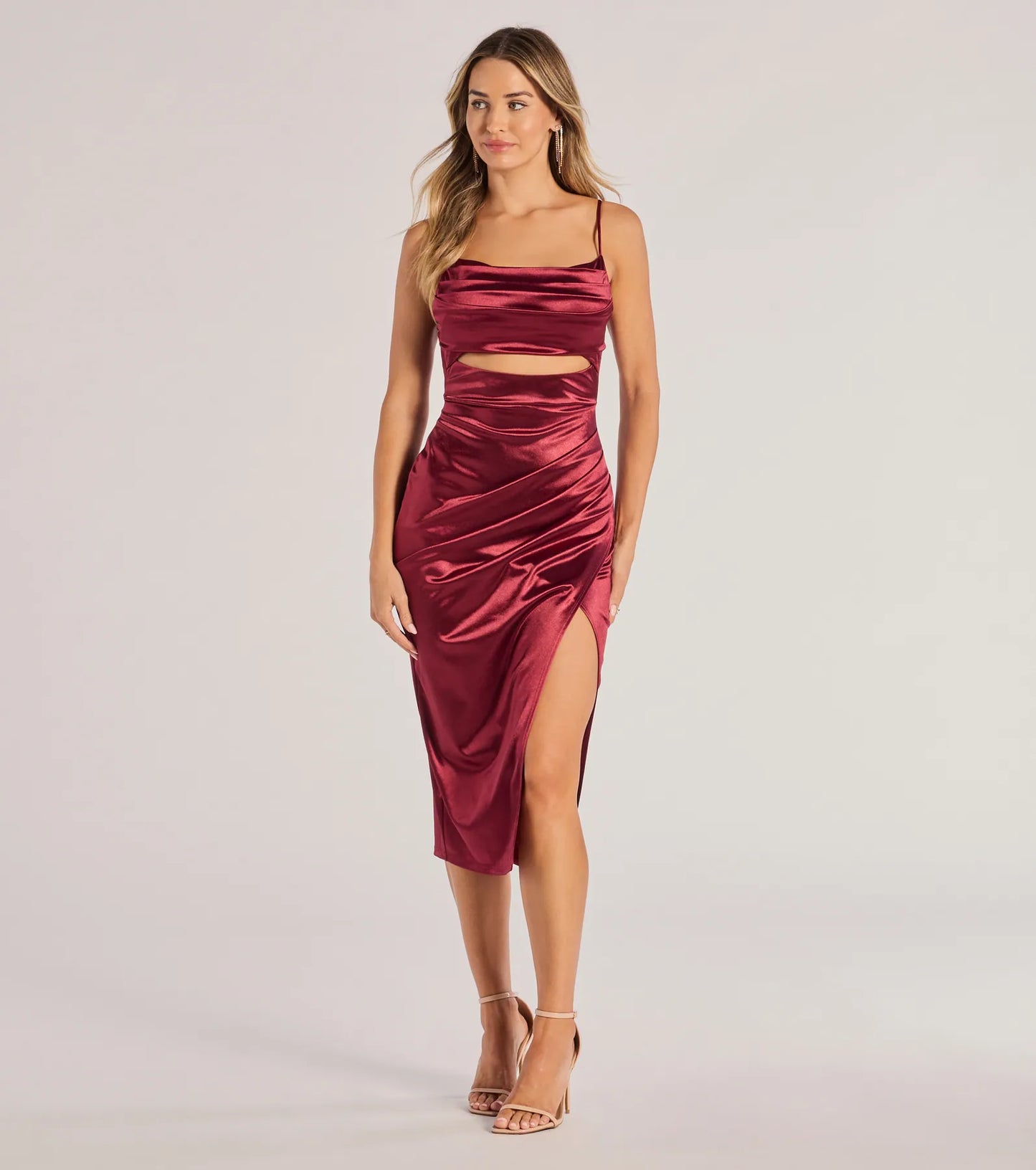 The Lilith Satin Cutout Wrap-Front Midi Dress in wine is a modern red dress featuring trendy details and a stunning design ideal for wedding guest dresses, elegant cocktail looks, or an alluring Valentine’s Day dress.